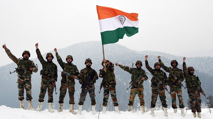 Army Jawans hold the National Flag and raise slogans near the snow-covered border Indian Army